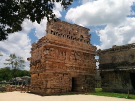 small temple bearing many masks in the Las Monjas complex